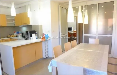 Kitchen with dining area and light-colored built-in units. - image 22