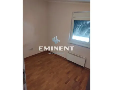 Empty room with parquet flooring and a single window. - image 13