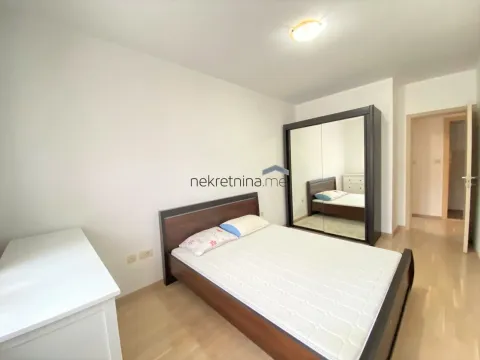 Furnished bedroom with a double bed and a large wardrobe. - image 8