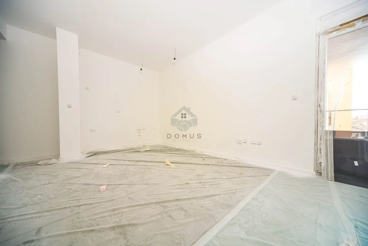 Empty room during finishing works with protective foil on the floor.