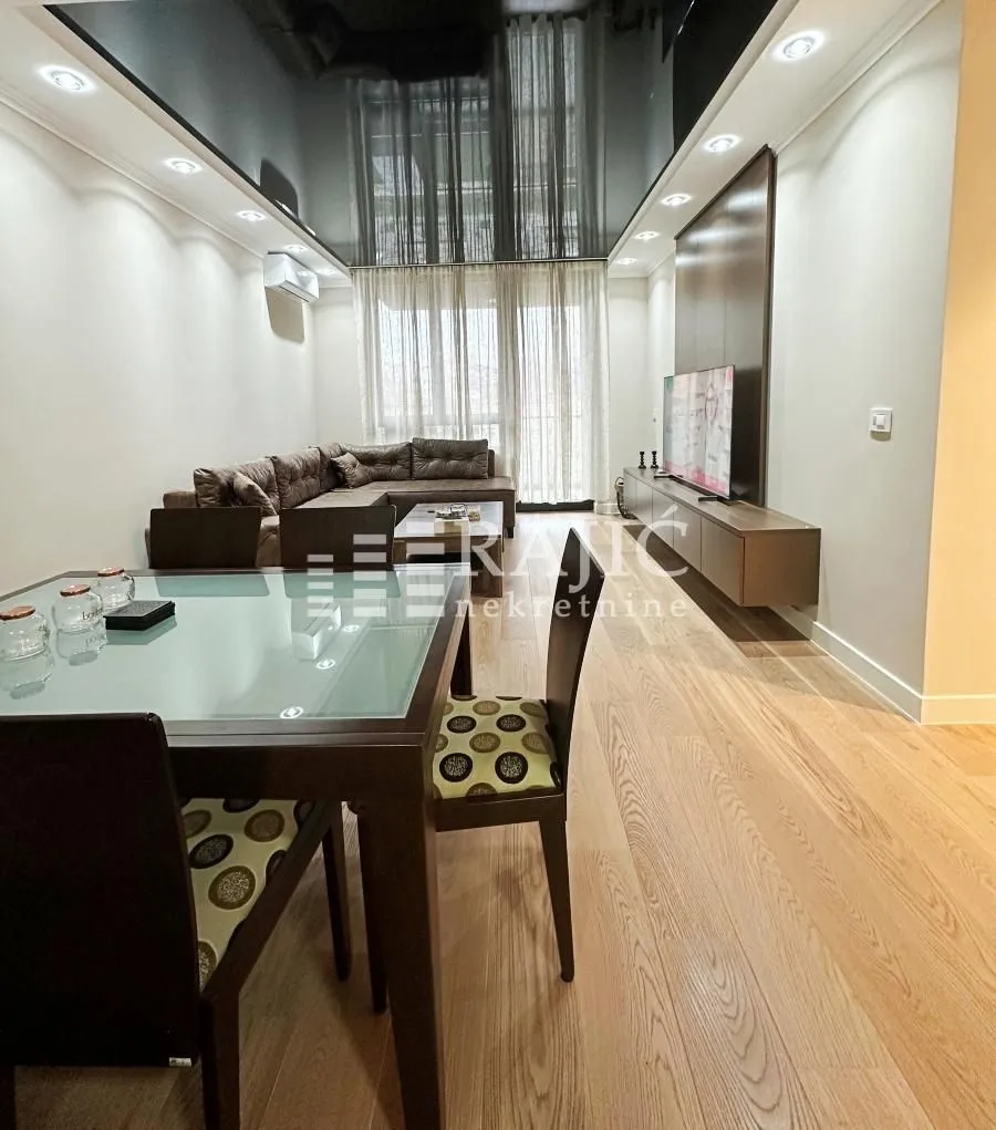 Living room with dining area and modern furniture.