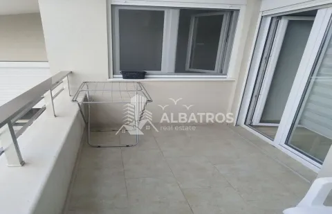 Smaller tiled balcony with a clothes drying rack. - image 10