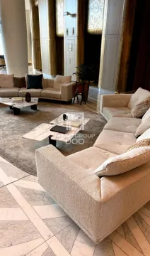 Spacious living room with seating sets and a coffee table. - image 3