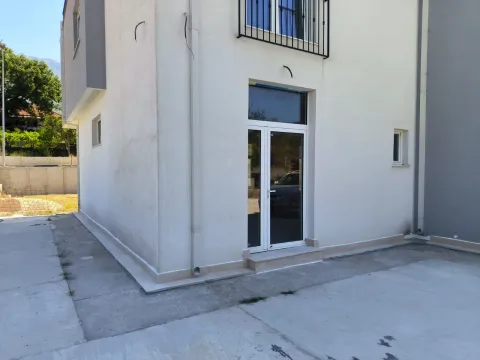 Exterior view of a house with a white facade and glass entrance doors. - image 11