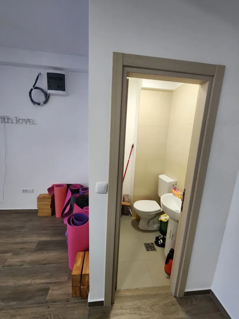 View from the hallway into a bathroom with a toilet and sink.
