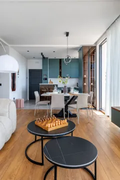 Living room with a dining area and kitchen in the background. - image 6