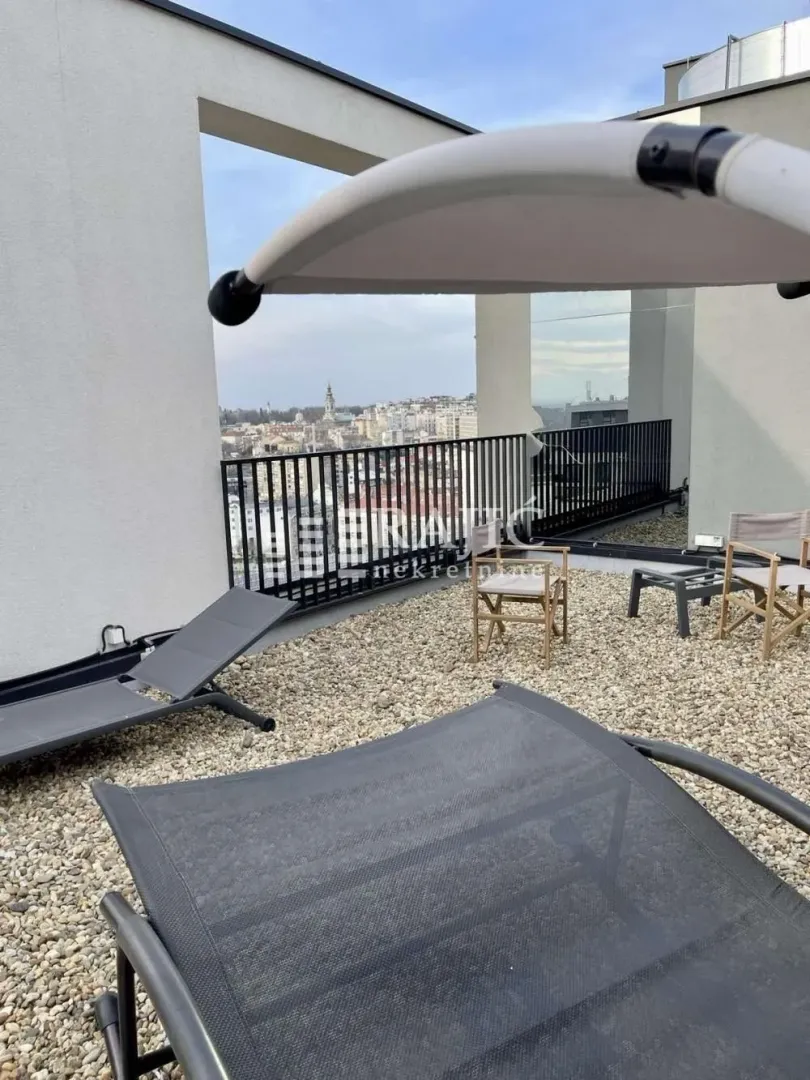 Roof terrace with outdoor seating and city views.