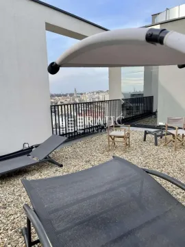Roof terrace with outdoor seating and city views. - image 15