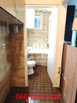 View from the hallway into the bathroom with tiles and sanitary fixtures. - image 7