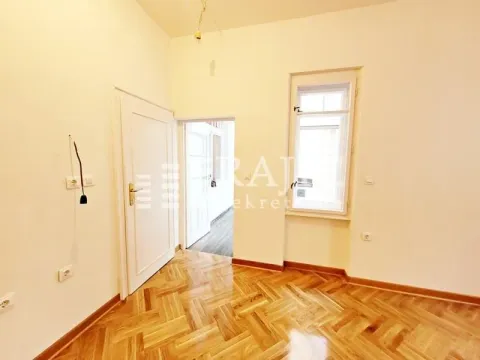 Empty room with wooden parquet flooring and white doors. - image 10
