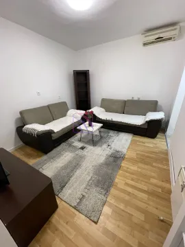 Living room with two sofas, a coffee table, and a rug. - image 2