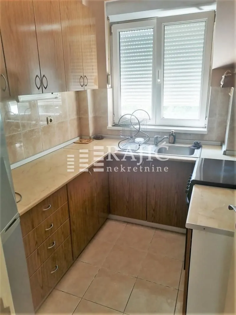 Small kitchen with wooden elements and a window.