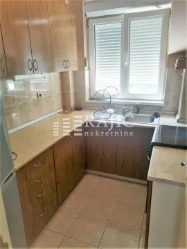 Small kitchen with wooden elements and a window. - image 3