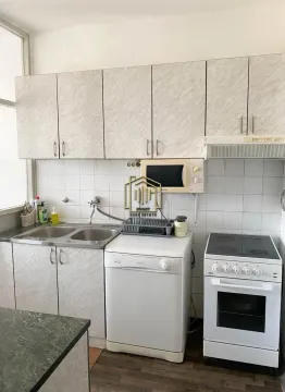 Compact kitchen with a sink, stove, dishwasher, and upper cabinets. - image 4