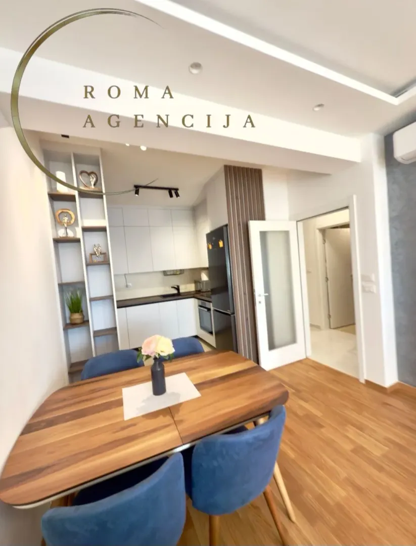 Modern kitchen with dining area and white cabinetry.