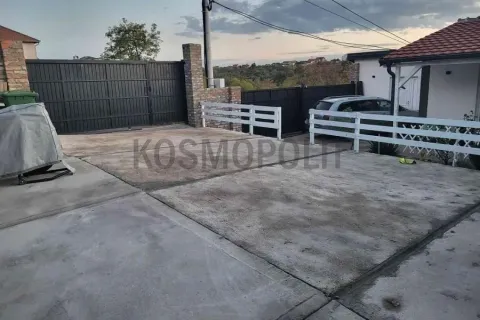 Concrete yard with a fence and entrance gate in front of the house. - image 3
