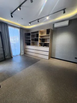 Empty room with a large built-in shelving unit and an air conditioner. - image 6