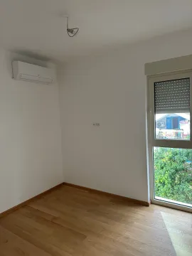 Empty room with hardwood floors, an air conditioner, and a window. - image 7