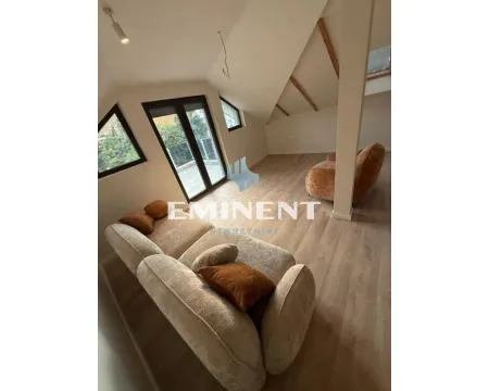 Attic living room with sofa set and roof windows. - image 2