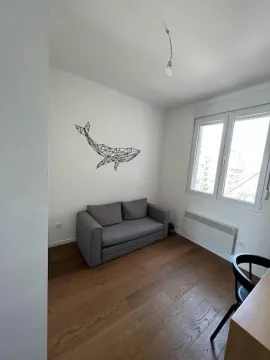 Smaller living room with a grey sofa and wooden flooring. - image 2