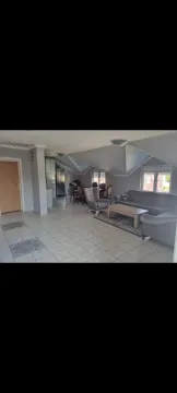 Spacious living room with a seating area and a dining section. - image 6
