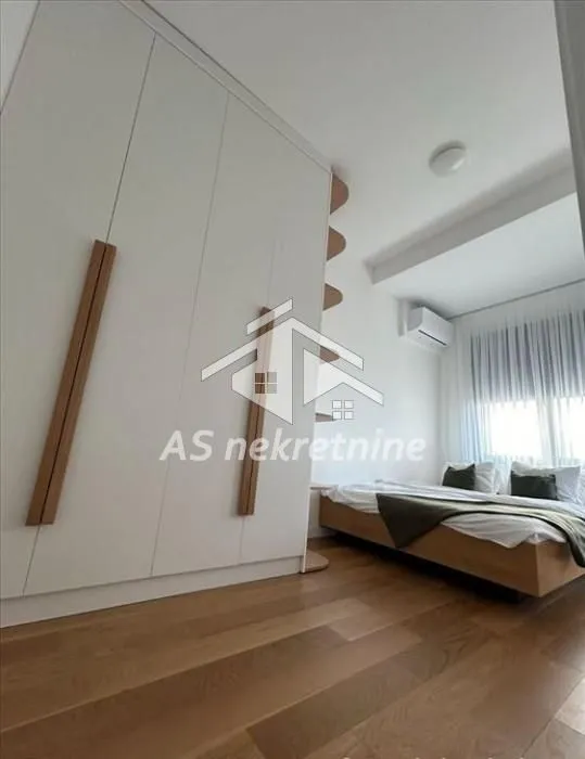Bedroom with a large built-in wardrobe and a double bed.