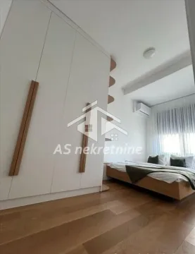 Bedroom with a large built-in wardrobe and a double bed. - image 11
