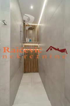 Modern walk-in shower with ceramic tiles and recessed lighting. - image 16