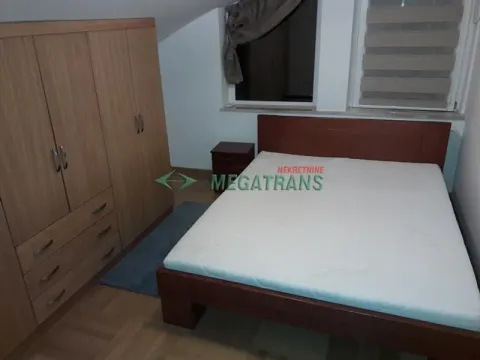 Furnished bedroom with a double bed, wardrobe, and nightstand. - image 10