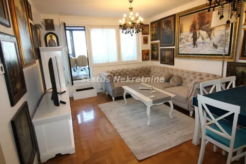 Living room with a sofa set, dining table and artwork on the walls. - image 3