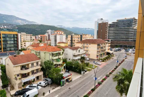 View from the terrace of the city street and surrounding buildings. - image 10