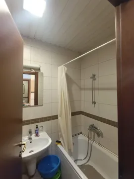 Manje kupatilo sa kadom, umivaonikom i pločicama na zidovima. - image 7