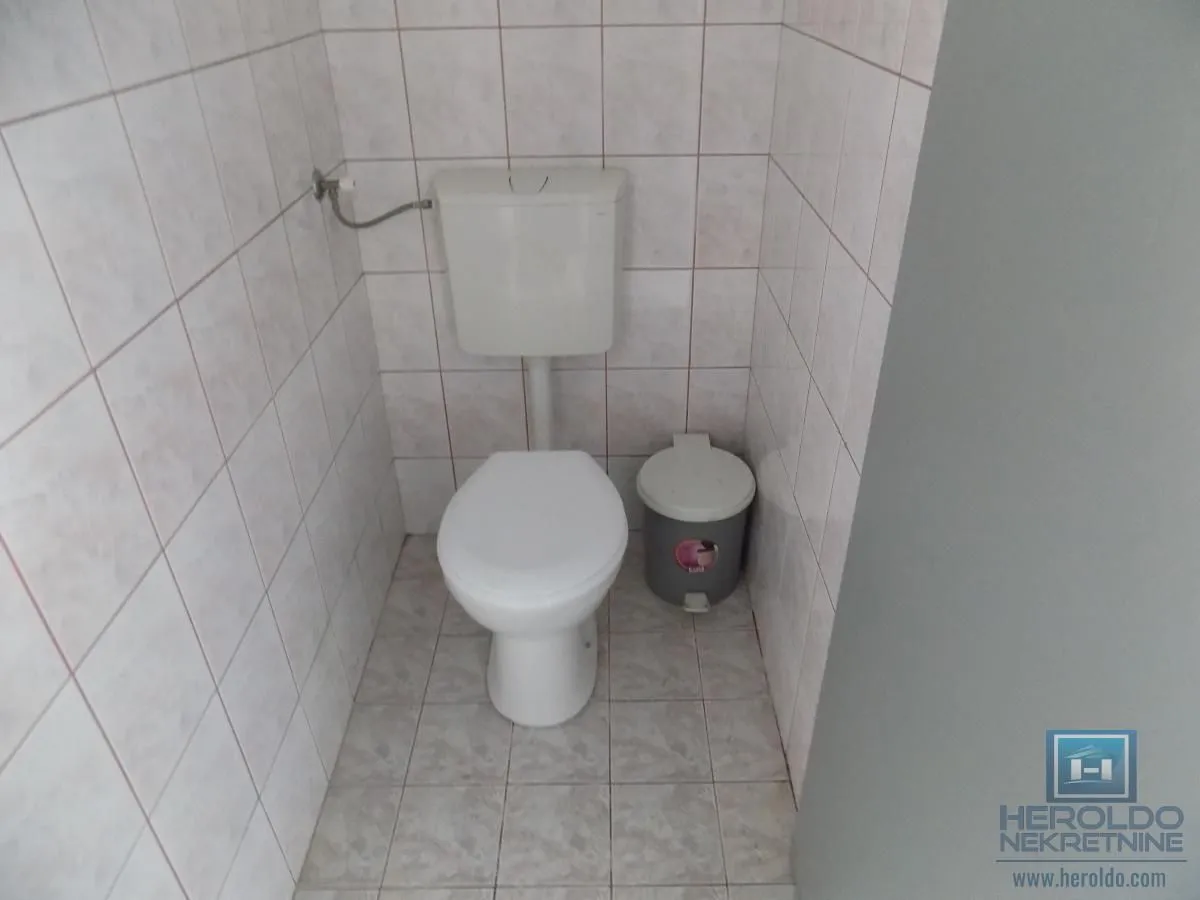 Smaller tiled bathroom with a toilet.