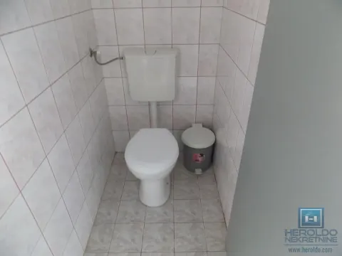 Smaller tiled bathroom with a toilet. - image 4