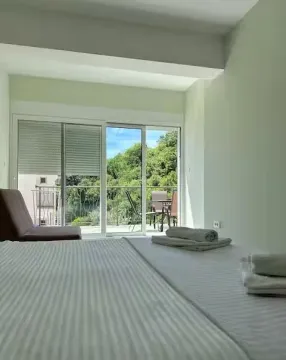 Bedroom with a double bed and access to the terrace. - image 12