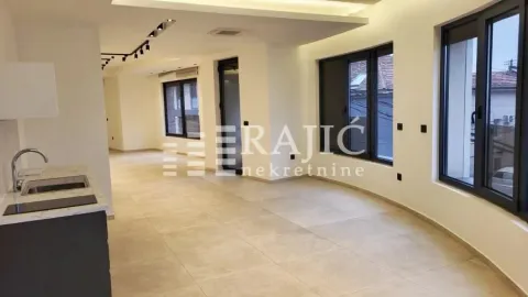 Spacious bright living room with an integrated kitchen and large windows. - image 4