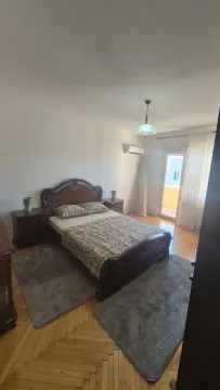 Spacious bedroom with a double bed, nightstands, and access to the terrace. - image 8
