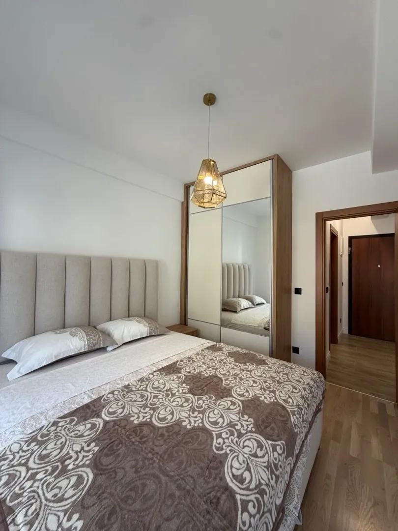 Furnished bedroom with a double bed and built-in wardrobe.