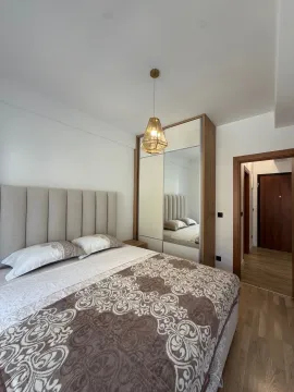 Furnished bedroom with a double bed and built-in wardrobe. - image 8