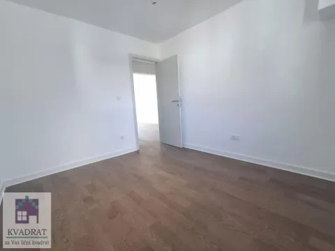 Empty room with wooden flooring and an open door. - image 11