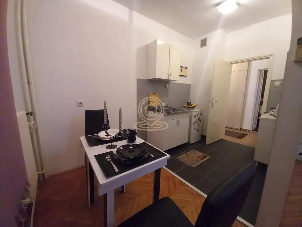 Small kitchen with a dining table and chairs.