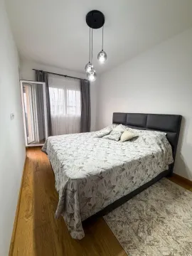 Bedroom with a double bed, wooden floor and access to the terrace. - image 4