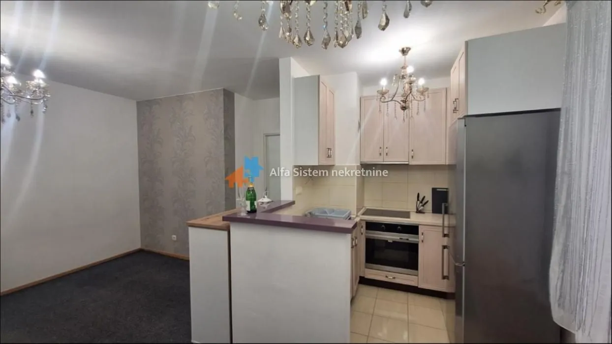 Small kitchen with a breakfast bar open to the living room.