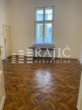 Empty room with parquet flooring and a window. - image 3