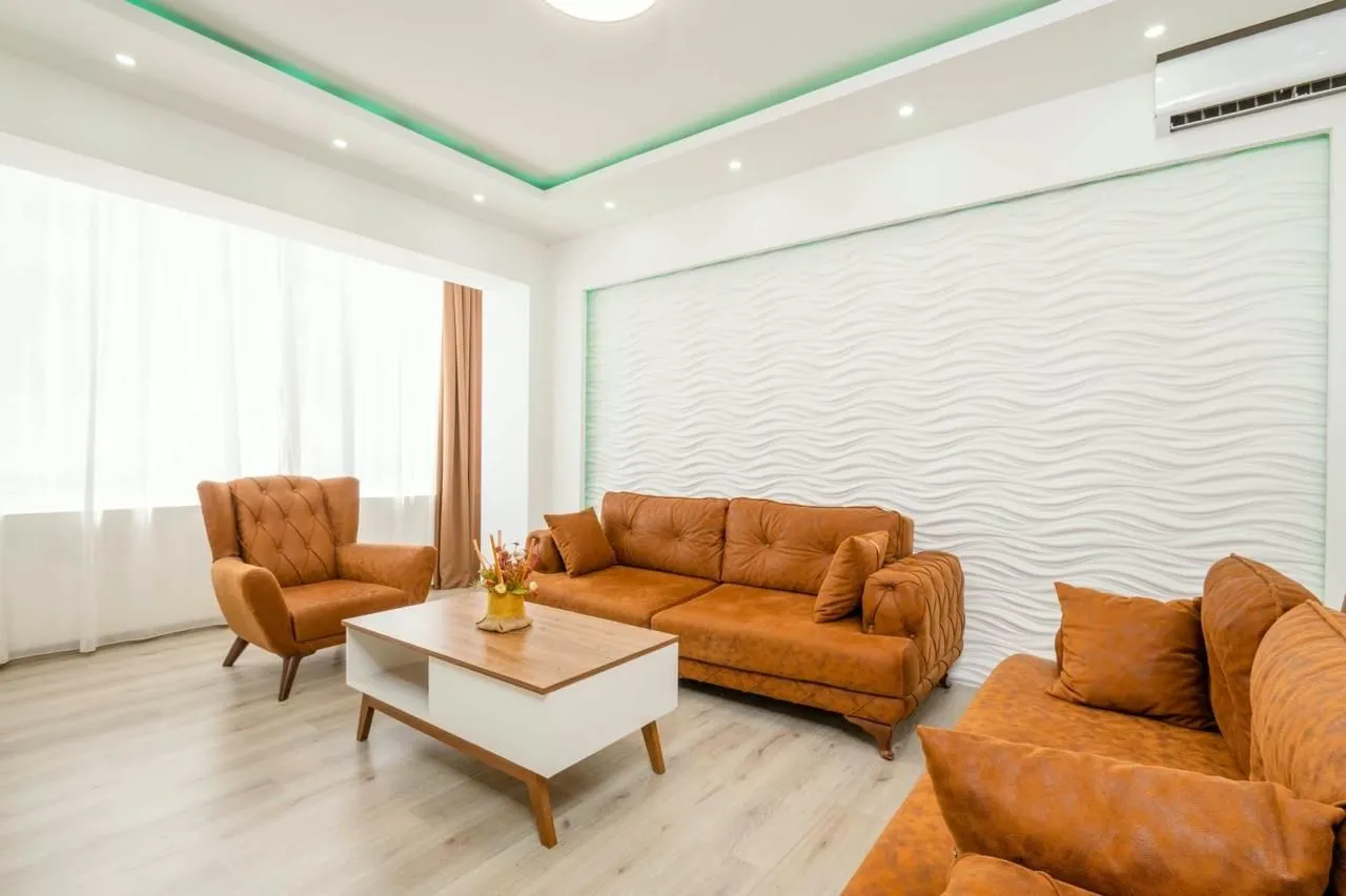 Bright living room with sofa set and coffee table.
