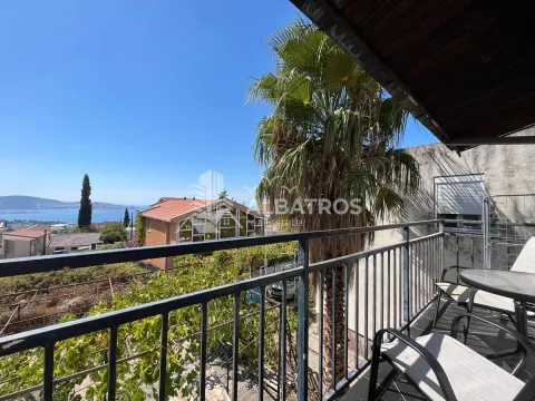 Covered balcony with outdoor seating and a view of the sea and surroundings. - image 11
