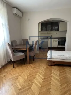 Living room with a dining area and a view of the kitchen. - image 7