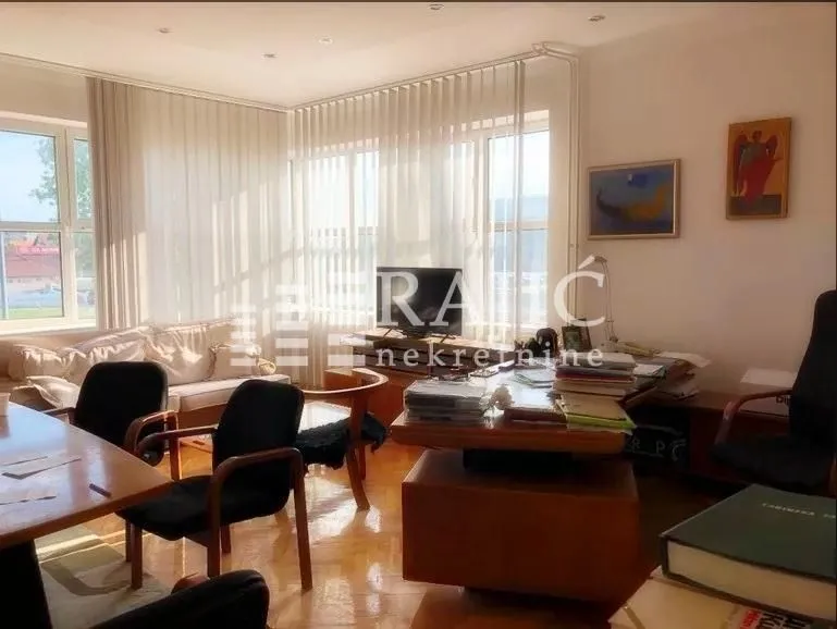 Spacious living room with a desk and seating set.