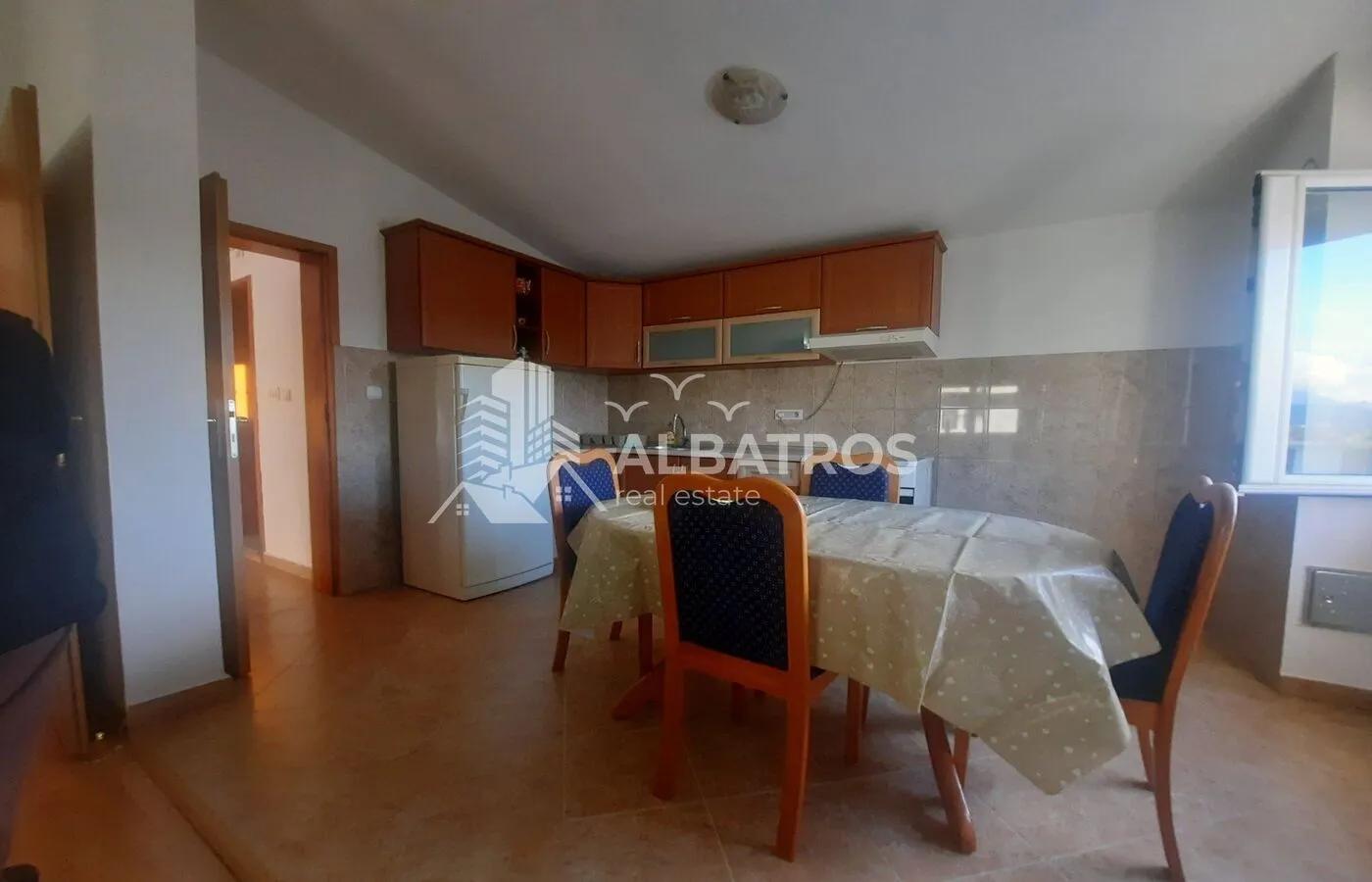 Kitchen with dining table and wooden cabinets.