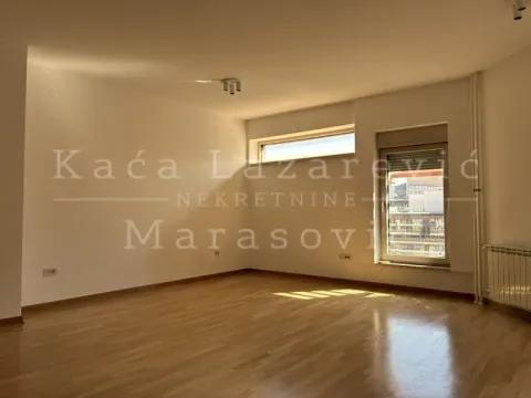 Empty room with wooden flooring and a window. - image 2